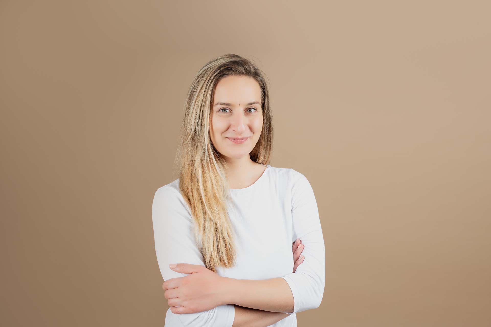 Modelling Headshots Cotswolds Professional photo of a model for her portfolio. She has blonde hair and is wearing a white long sleeved top