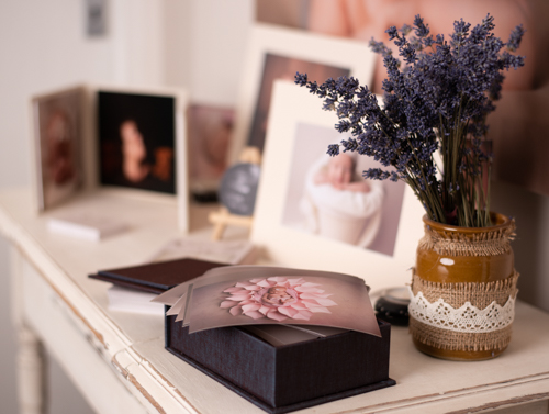Prints and gifts on a table with a pot of lavender