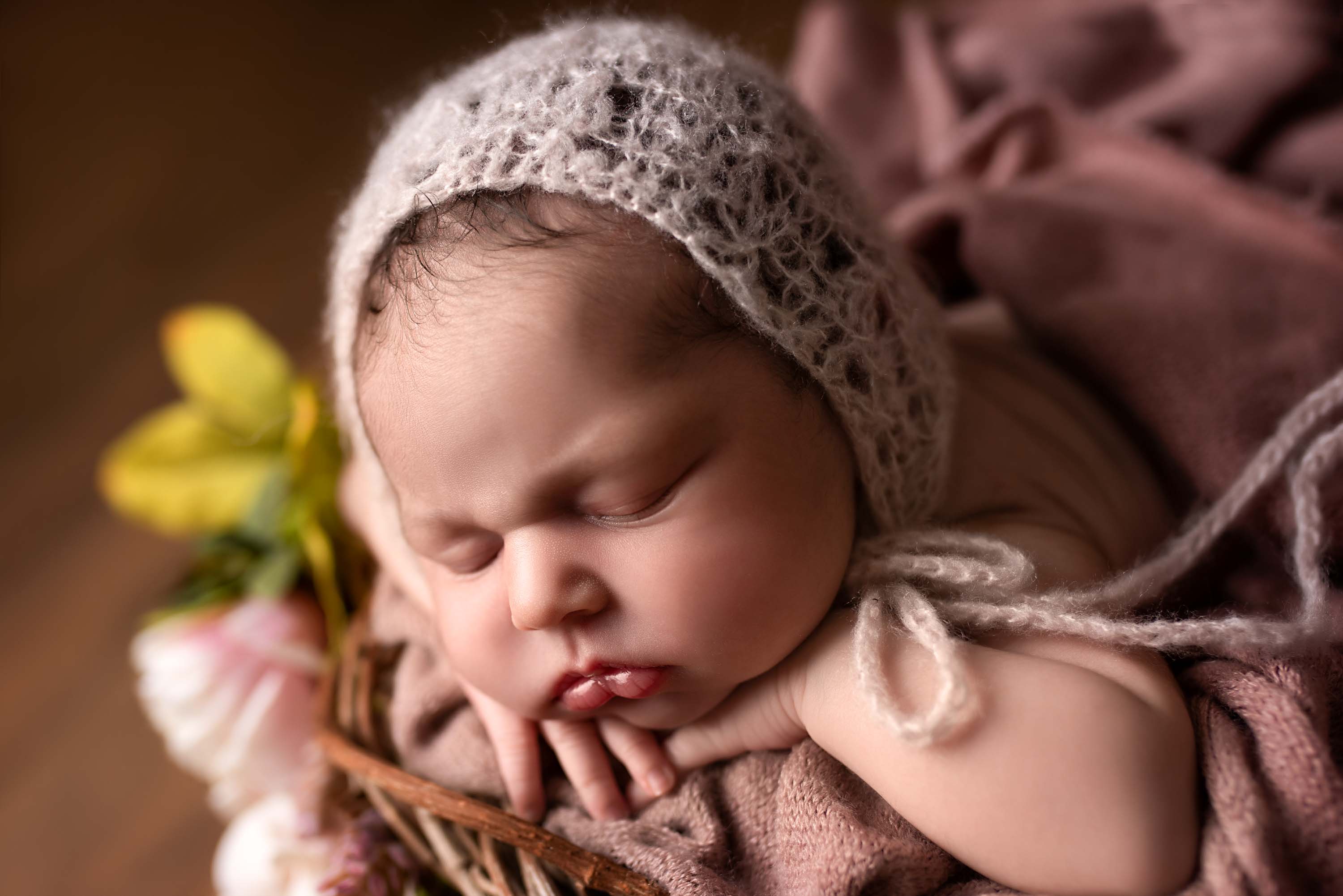 Newborn photography crocheted bonnet on a baby girl