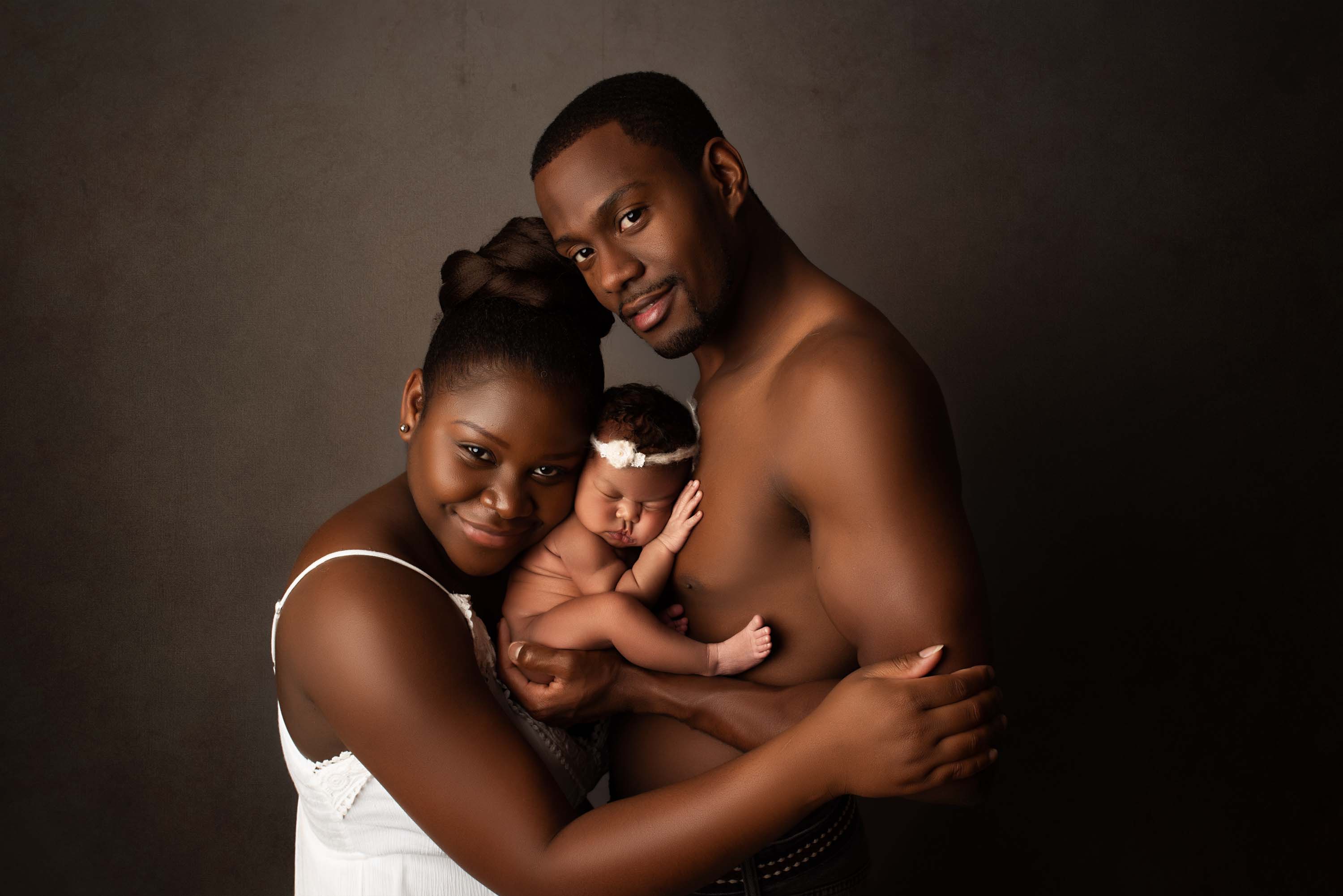 New parents doing skin-to-skin with their new baby girl