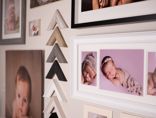 Wall of sample prints and frames that you could use for your Christmas baby photoshoot