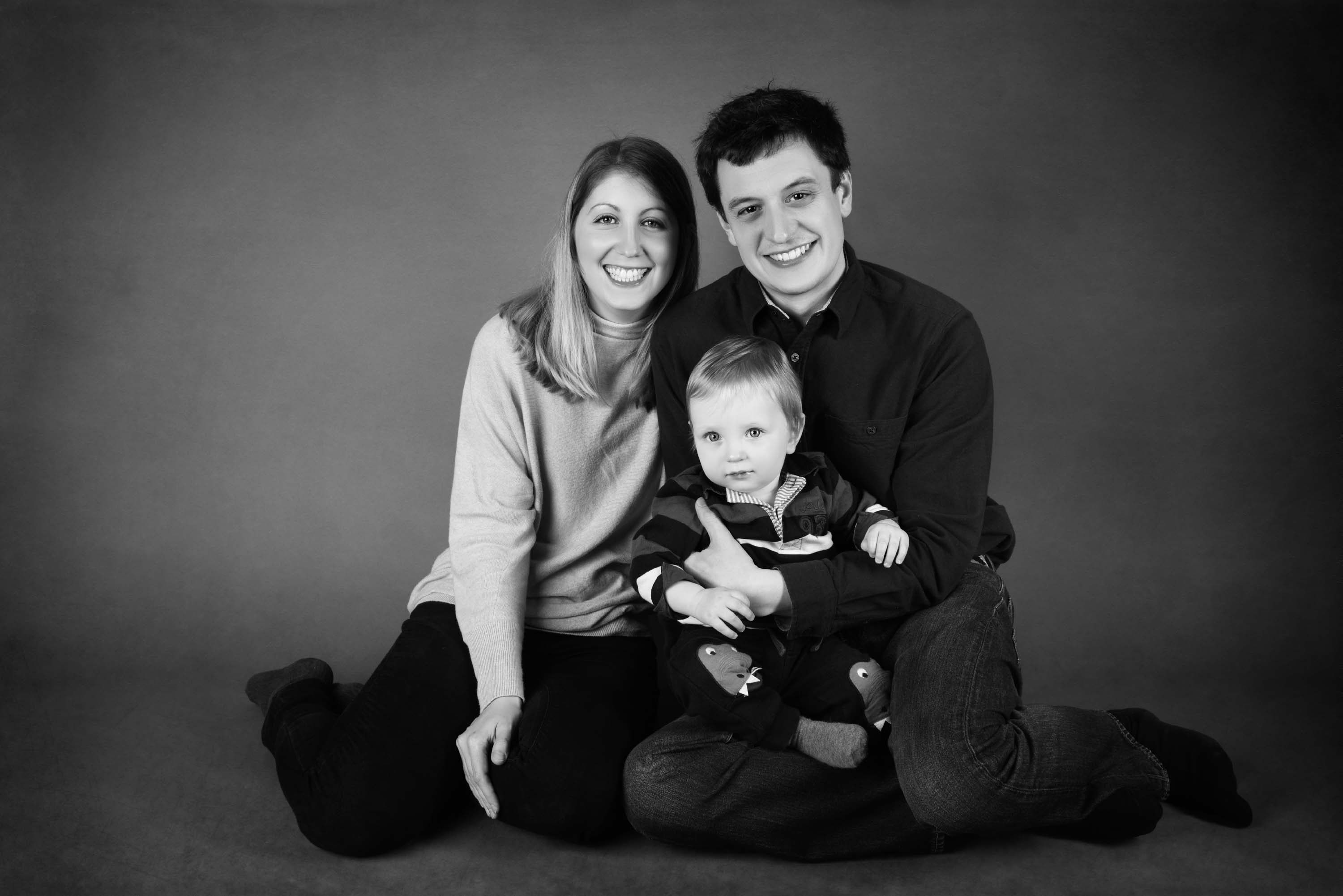 Black and white of mum, dad and their one year old boy