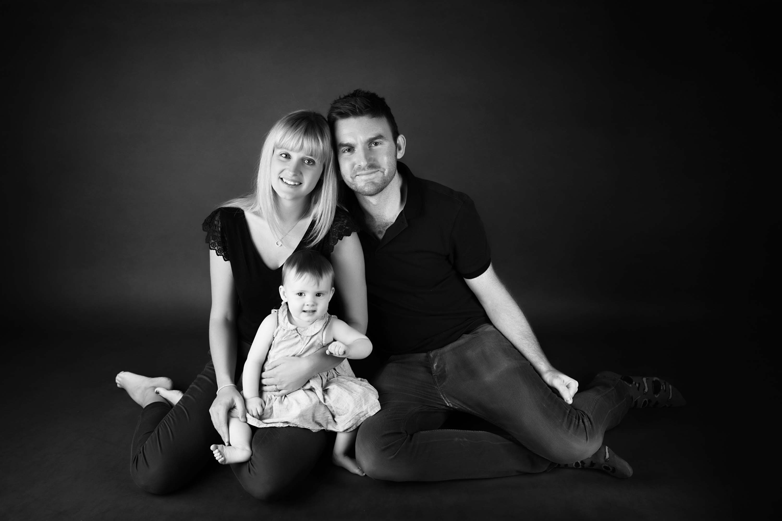 Family portrait of mum, dad and daughter at her cake smash photoshoot