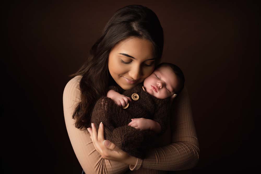 New mum cuddling her son