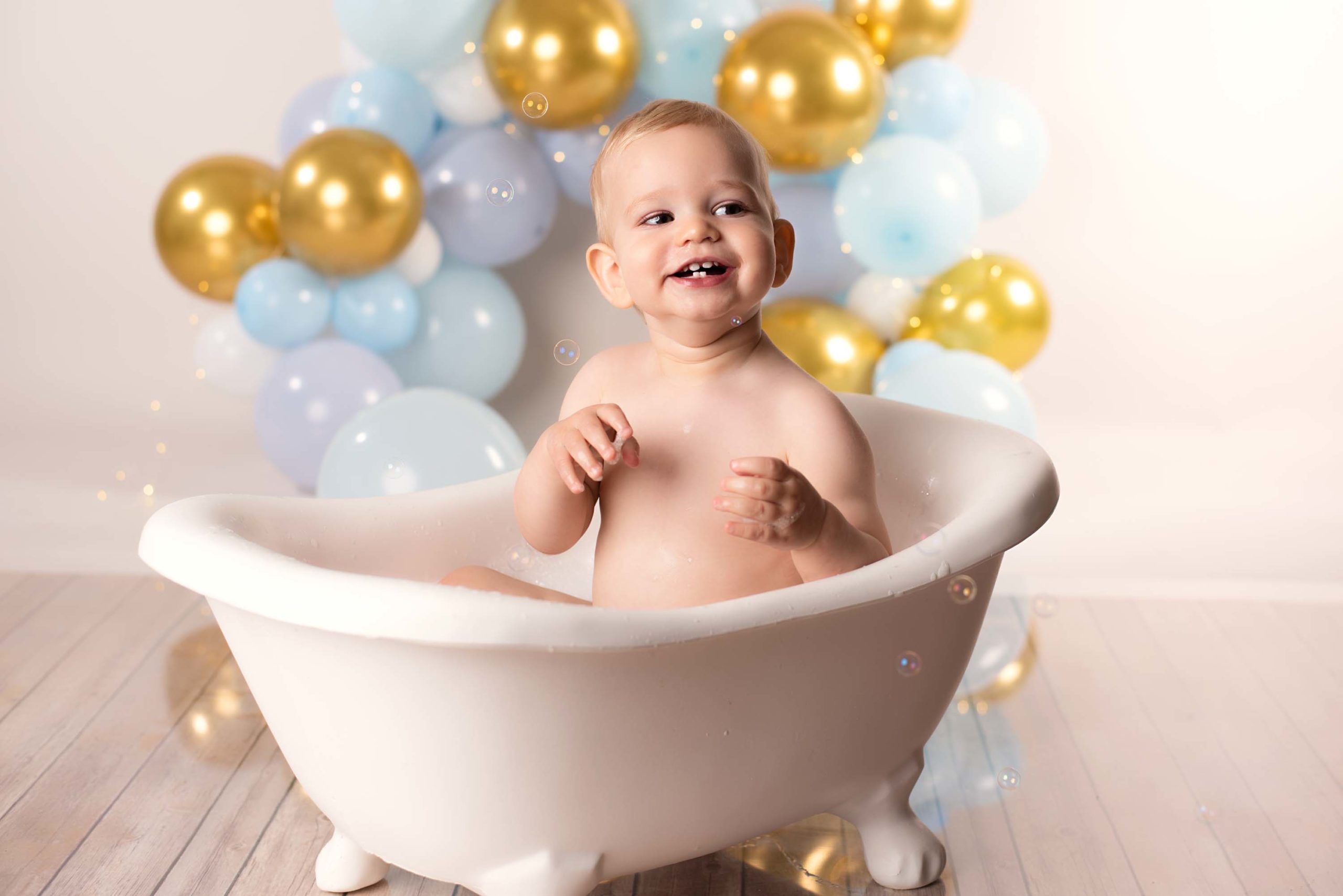 Little boy smiling in bath tub
