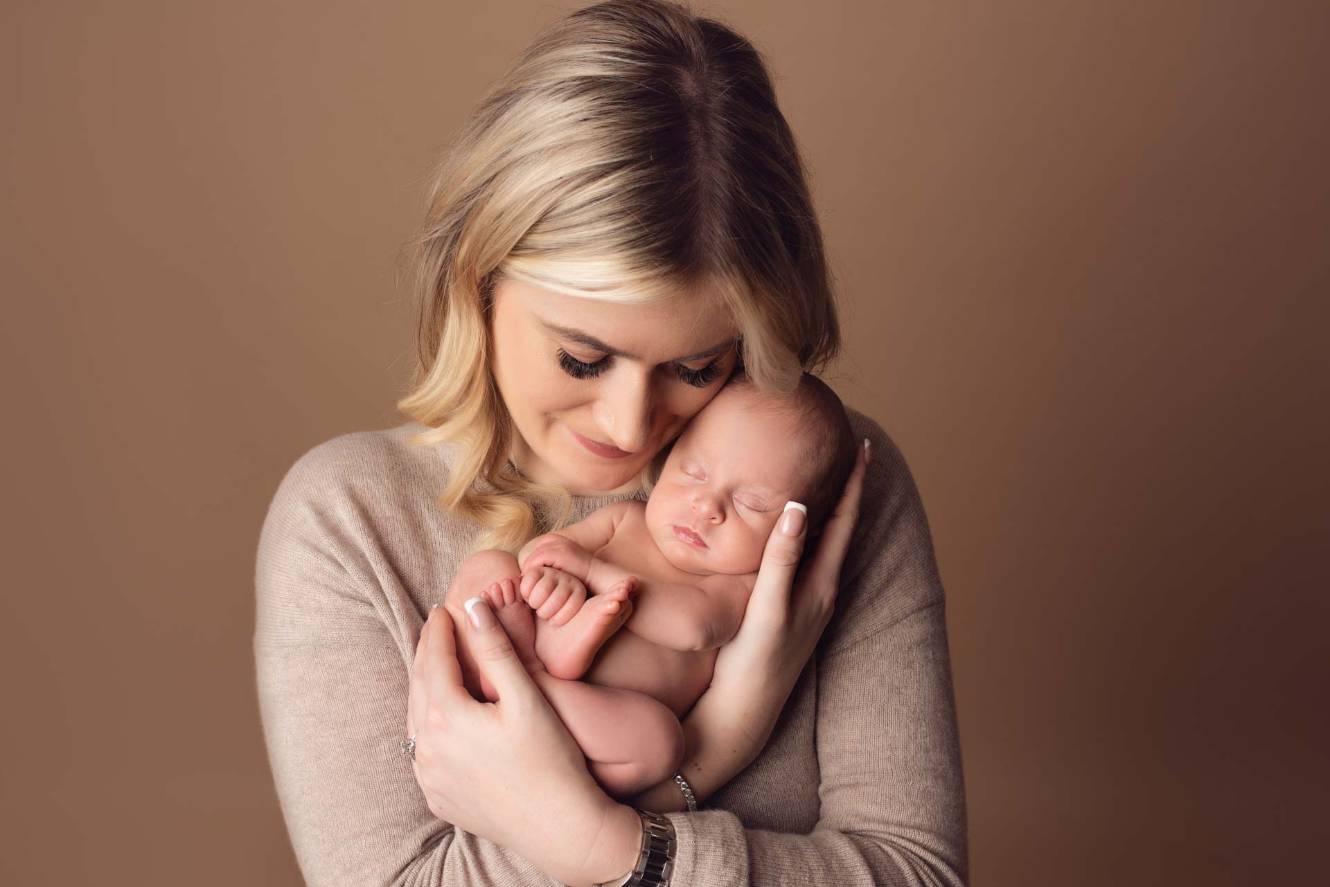 New mummy cradling her baby daughter