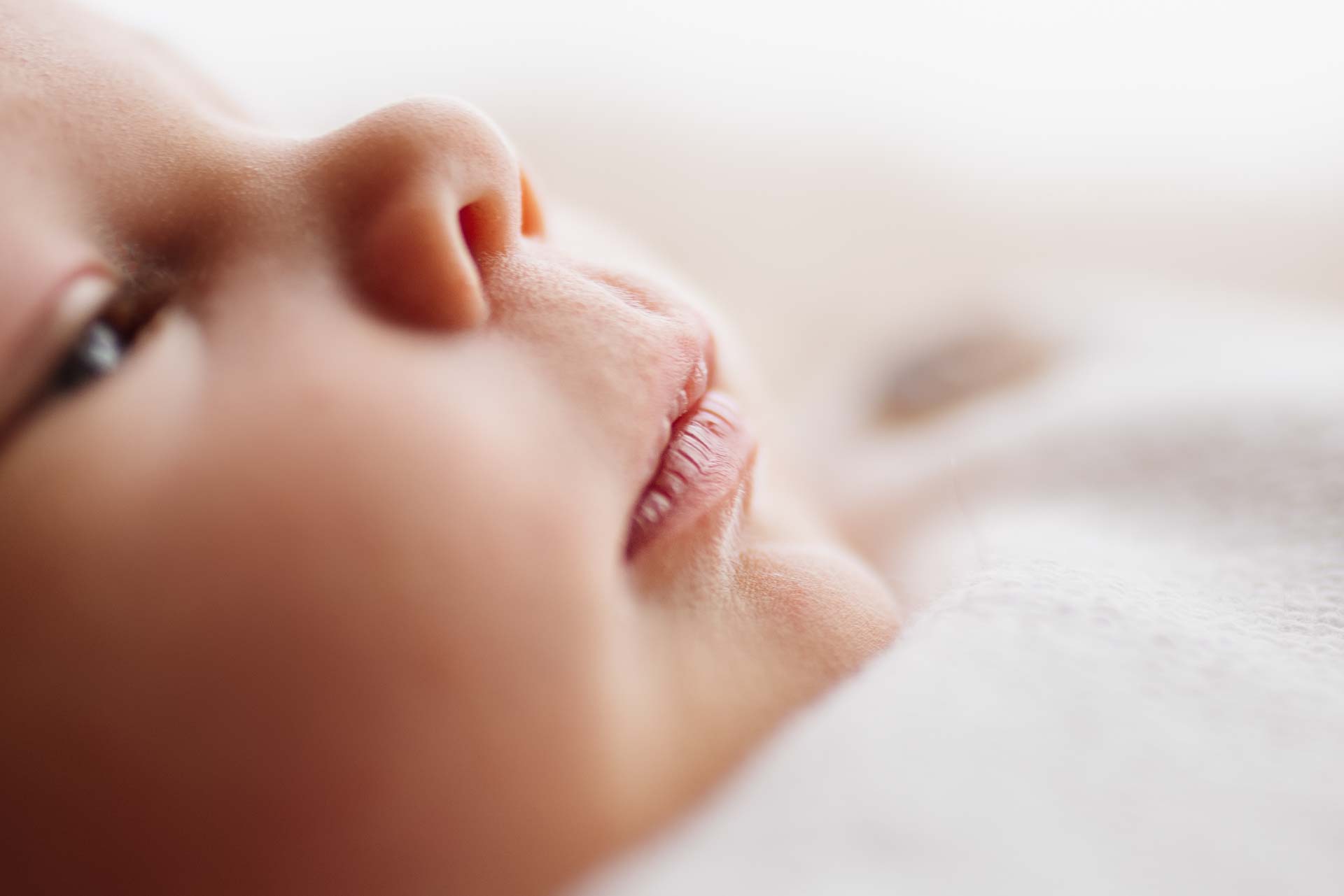 Close up photograph of new baby boy's lips