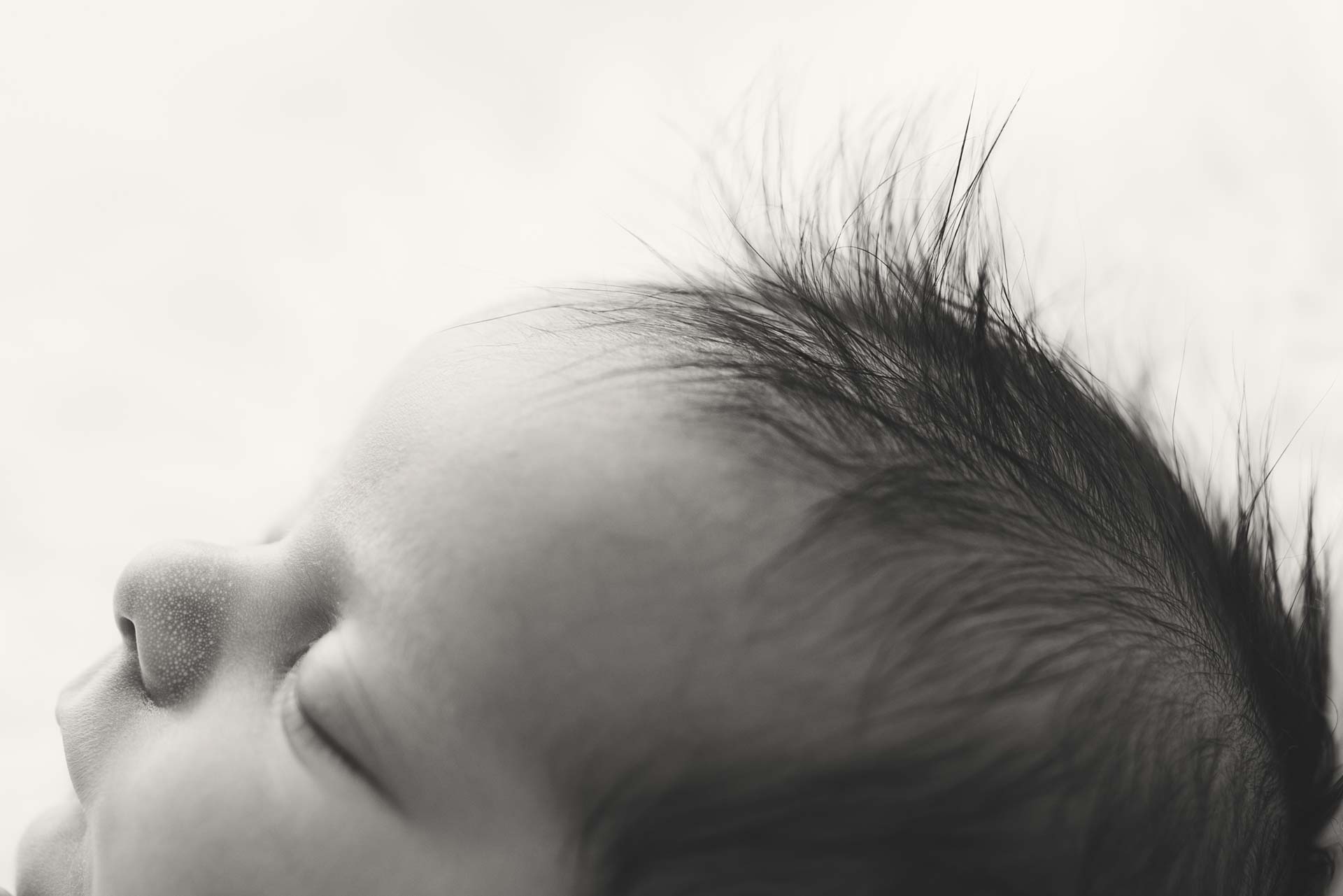 Close up photograph of a newborn baby's spiky hair