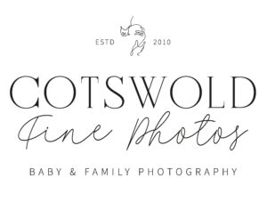 Business logo for a family photographer called Cotswold Fine Photos with a symbol of a mother kissing her baby's head