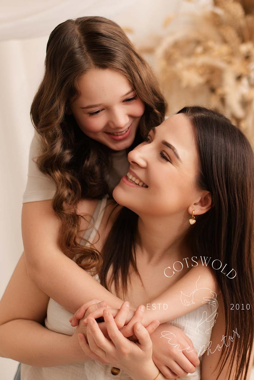 Mother and daughter embracing during their mummy and me photoshoot