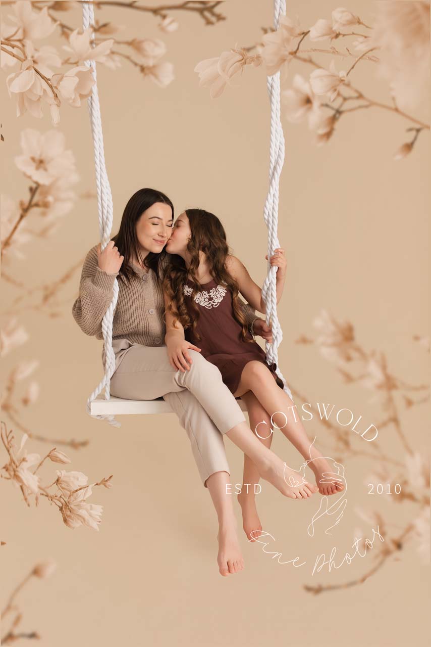 Daughter kissing Mummy during the photoshoot in the Cotswolds