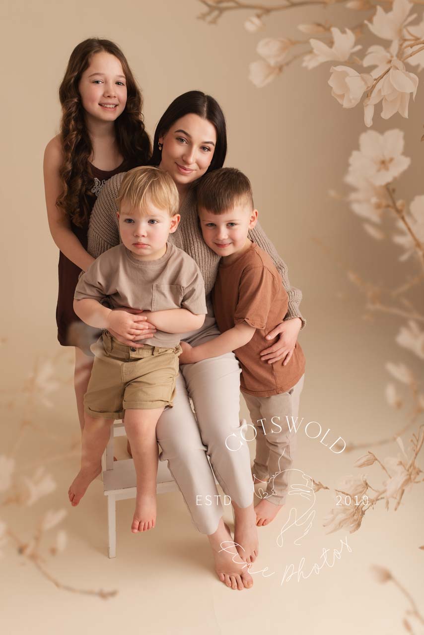 Mother and daughter sitting in front of a Christmas tree at their annual photoshoot