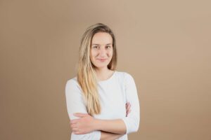 Professional photo of a model for her portfolio. She has blonde hair and is wearing a white long sleeved top