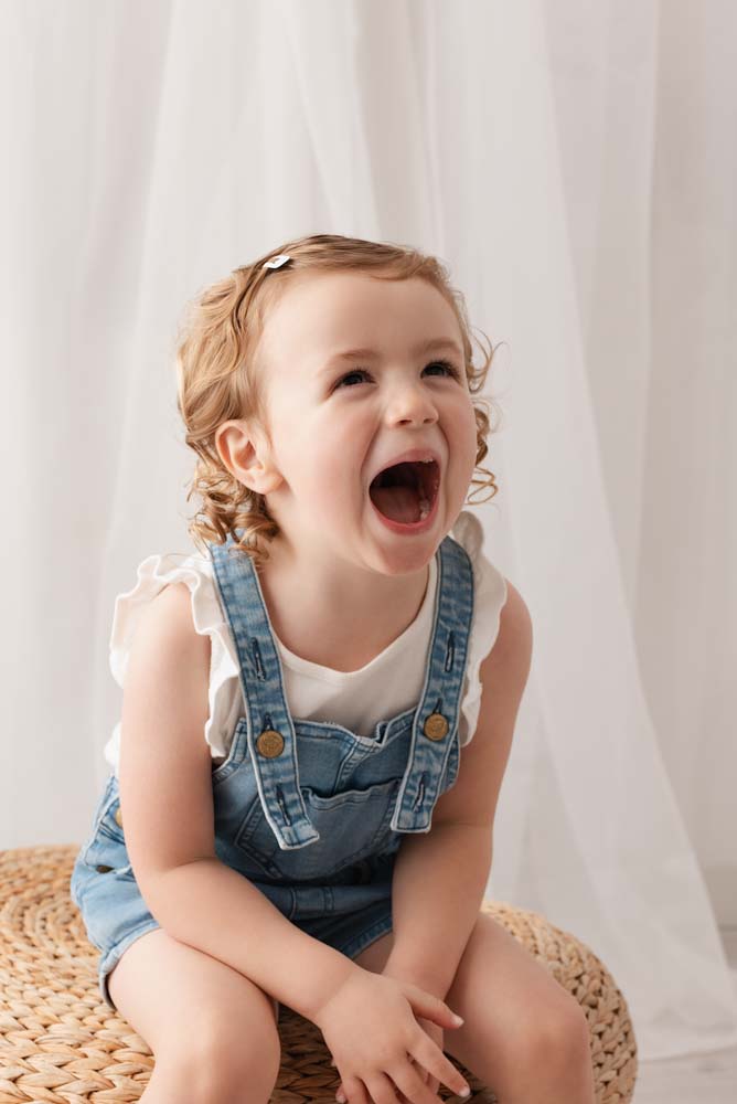 Child having a great time at her nursery photoshoot