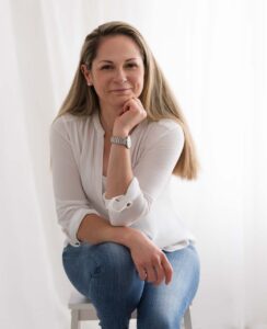 Business women with her head on her hand sits for her professional headshot