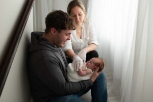 Father holding newborn baby in Chipping Norton studio