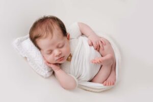 Newborn baby sleeping on soft white blanket
