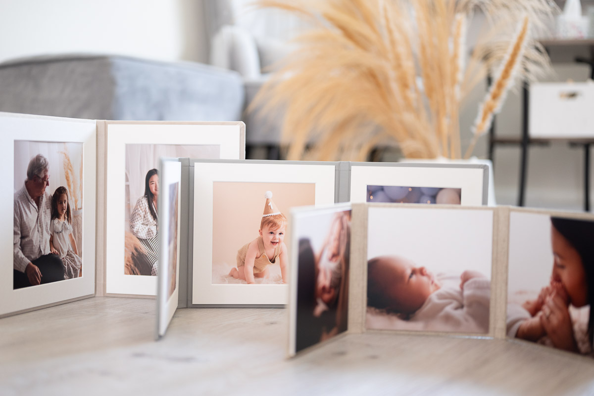 Selection of trio folios photographed on the floor of the photography studio for the family photography prices Oxfordshire website