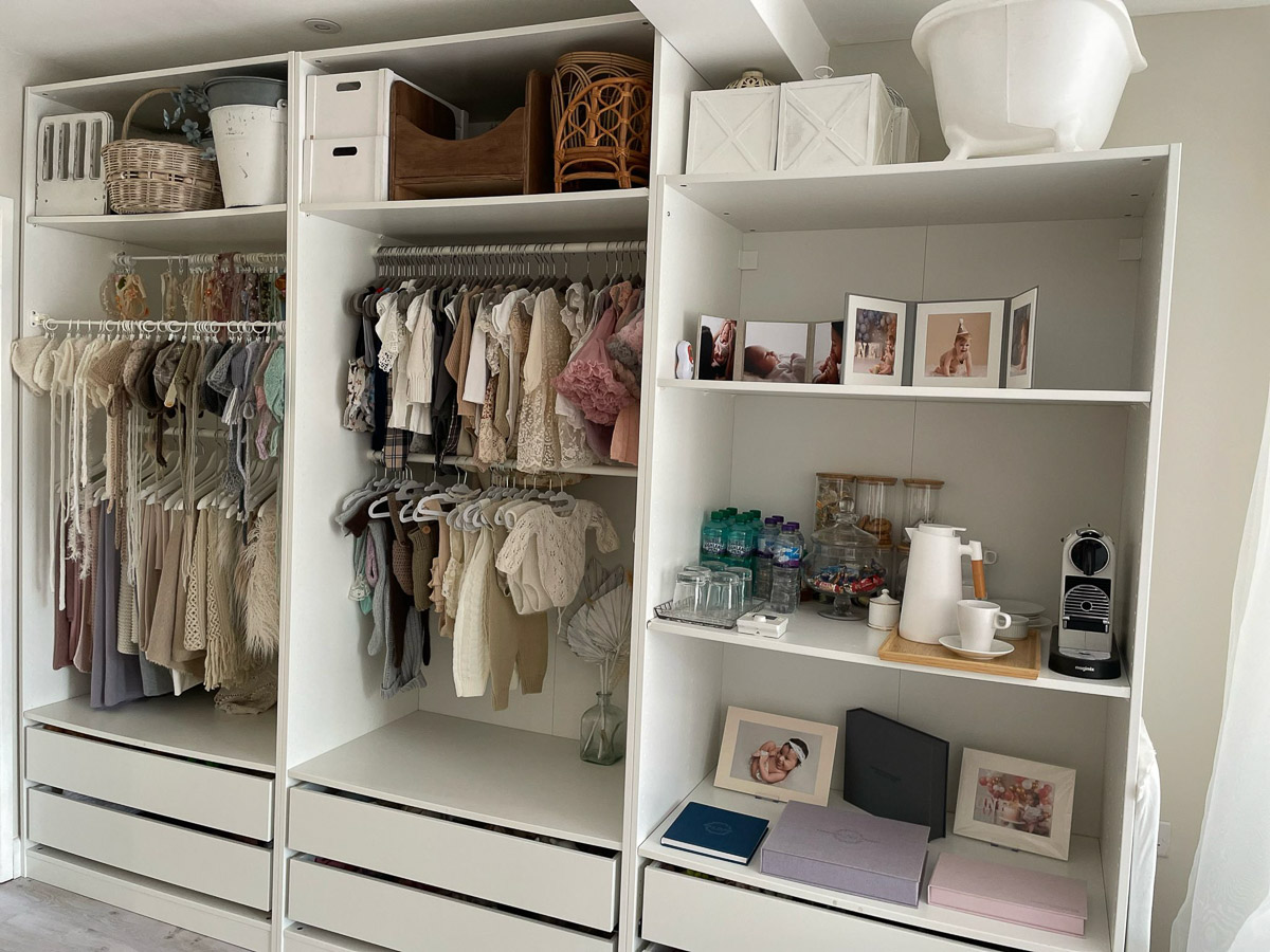 Baby and kids clothes as well as props on shelves in the Cotswold Fine Photos studio